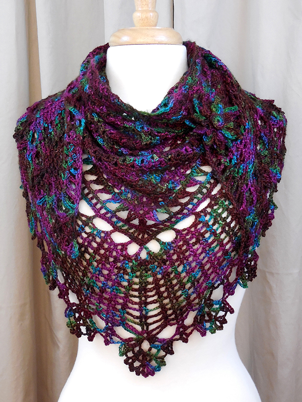 lacy crochet triangle shawl with flower pin