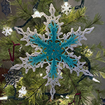 lacy crochet snowflake in colors of water