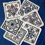 Blackwork embroidery to interlocking filet crocheet