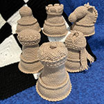 amigurumi chess set with checkerboard afghan