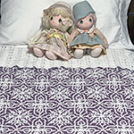 interlocking filet crochet afghan with repeating snowflake design