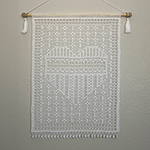 Thread crochet wall hanging with filet crochet heart design.