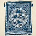 filet crochet wall hanging with whimsical bird design