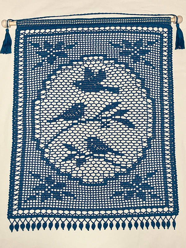 filet crochet wall hanging with whimsical bird design